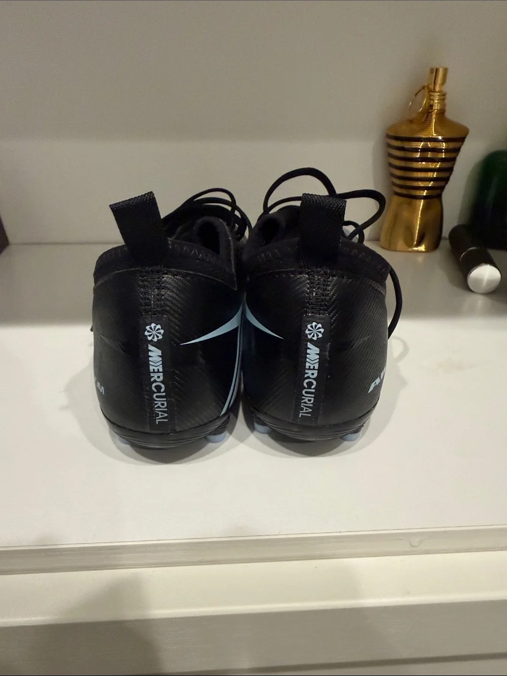 Nike Men’s Black Athletic Cleats with Light Blue Swoosh